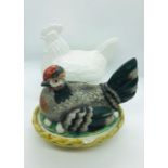 Two ceramic egg holders in the shape of chickens
