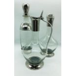 A set of three modern chrome and glass decanters by Eichholtz