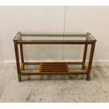 A Contemporary glass topped console table with brass corner detailing by Pierre Vandel Paris (H 75