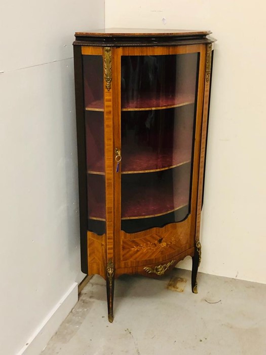 An Ornate corner cabinet with brass detailing, marquetry and a curved glass door and three shelves. - Image 2 of 5