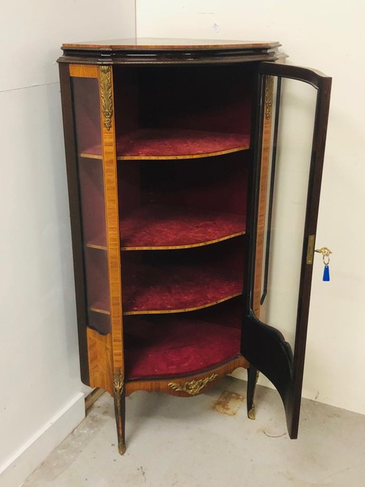 An Ornate corner cabinet with brass detailing, marquetry and a curved glass door and three shelves. - Image 3 of 5