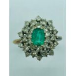 A Diamond and Emerald ring set in a hallmarked 18ct gold setting