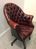 An Ox Blood Chesterfield style Captain chair