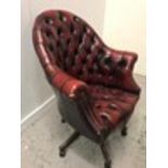An Ox Blood Chesterfield style Captain chair