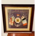 A Framed World War One 'United We Stand' silk with a central photo of a young man.