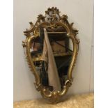 An Ornate gilt framed hallway mirror.