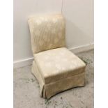 A Bedroom Chair in Cream and Green upholstery with grape vine pattern