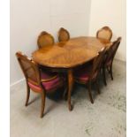 An Ornate Regency style Dining Table with centre leaf, double rim edges and cabriole legs, six