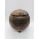 A round wooden tobacco jar on white metal ball feet