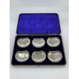 A boxed set of silver butter dishes, hallmarked.