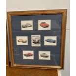 A framed print of Mercedes cars.