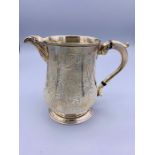 A hallmarked silver milk jug, dated London 1764 (See photo for makers mark)