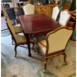 An Oriental cherry wood Dining room table with six chairs and two carvers