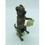 A Bergman Austrian bronze dog sitting on a potty reading a newspaper, bearing makers mark