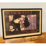 A framed Vintage Victor Bicycles poster.