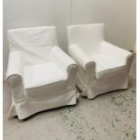 A Pair of white loose covered arm chairs