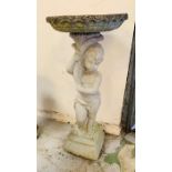 A stone bird bath with figure of a child holding up the bath (H86cm X D38cm)