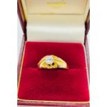 A solitaire diamond ring in an 18ct yellow gold setting.