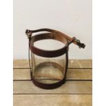 A Leather and glass hurricane style candle holder