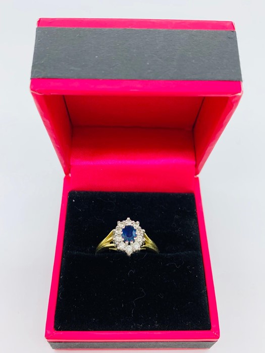 An 18ct yellow gold cornflower sapphire and diamond ring in the daisy style