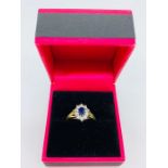 An 18ct yellow gold cornflower sapphire and diamond ring in the daisy style