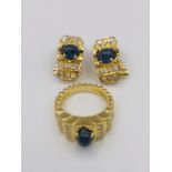 By Vourakis: A set of 18ct gold earrings and 18ct gold ring. Each set with a large cabochon sapphire