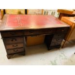 A red leather topped pedestal desk