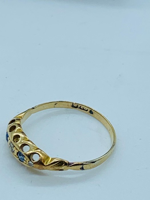 An 18ct yellow gold ring with three small stones. - Image 2 of 2