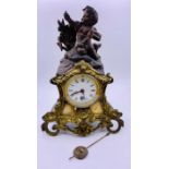 A Mantle clock with Cherubic figure, gilt and marble surround.