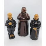 Three treacle glazed decanter figures of which two are monks