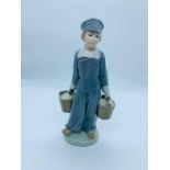 A Lladro figure holding two pails