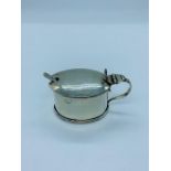 A hallmarked silver mustard pot with blue glass liner and spoon. Birmingham 1904, makers mark D S.