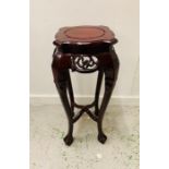 An Oriental cherry wood carved plant stand