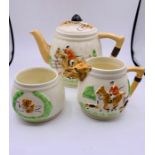 A Keele Street Pottery Hunting themed tea set to include teapot, sugar bowl and milk jug.