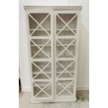 White bookcase with geometric cut out doors