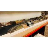 A model railway layout with power control unit, station houses, bridges, wagons of various makers