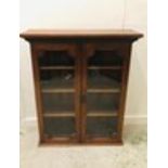 A Glass Fronted bookcase with three internal shelves (H123cm W104cm D34cm)