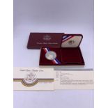 A USA 1984 Olympic silver dollar proof coin in box with certificate.