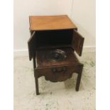 A Commode with small cupboards above and brass side handles (59cm X 69cm)