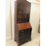 A Large Georgian mahogany bureau bookcase with four graduated drawers on bracket feet with glazed