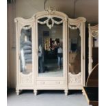 A Very large hand painted ornate antique wardrobe with three mirrored doors and three hanging