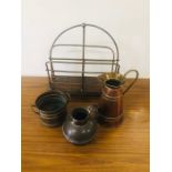 A Brass and wooden magazine rack with a selection of copper and brass items to include a jug by