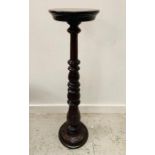 Mahogany torchere with a leaf carved stem