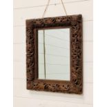 A Raised carved wooden mirror (50cm X40cm)