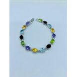 A Silver line bracelet set with amethyst, citrine, garnet, peridot and aquamarine