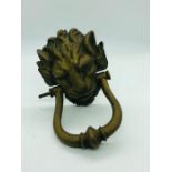 A Brass lion head door knocker