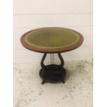 A Small oval leather topped mahogany side table with harp base