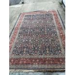 A Heavy hand knotted Turkish rug with a red floral boarder (250cm X 300cm)