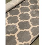 A Large pale grey and cream patterned circular rug