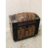 A Large wooden and metal pirate style treasure chest on castors